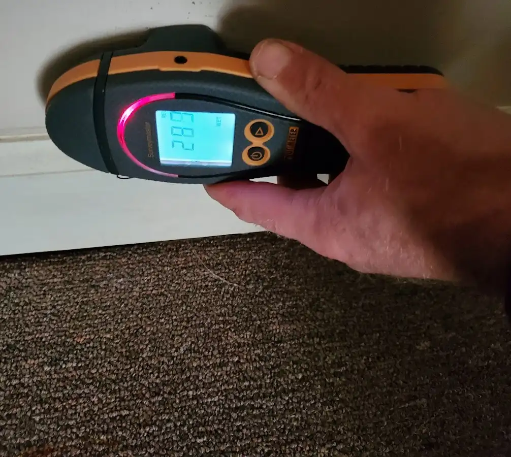 Moisture detection at baseboard during Storm Damage Restoration in Independence